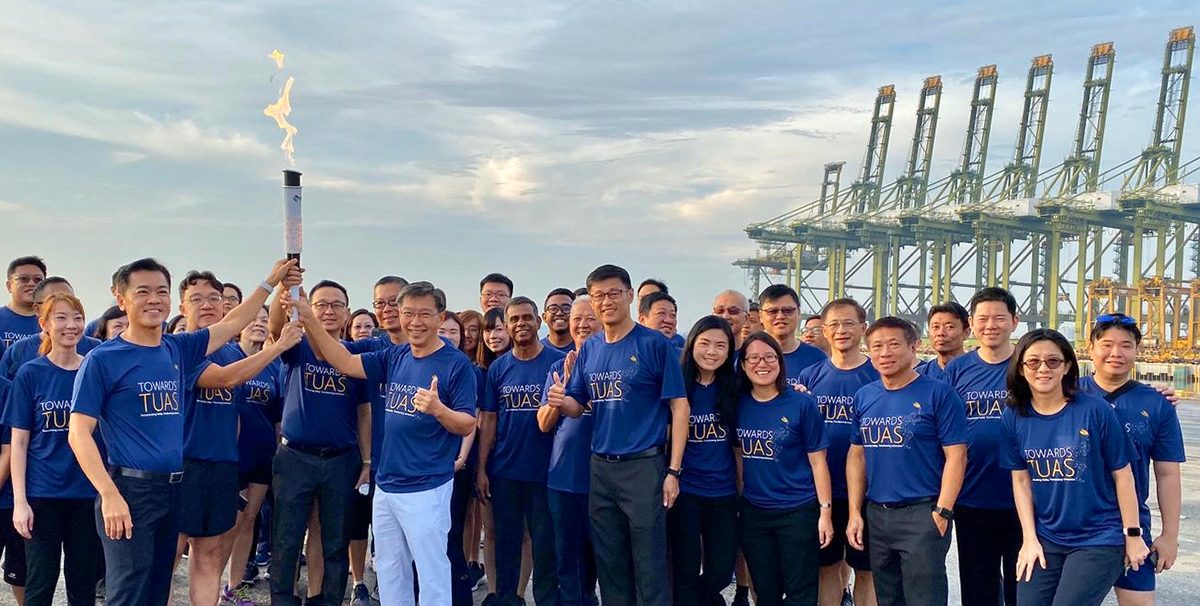 PSA Begins A New Chapter with Tuas Port in Singapore A group photo with the torch
